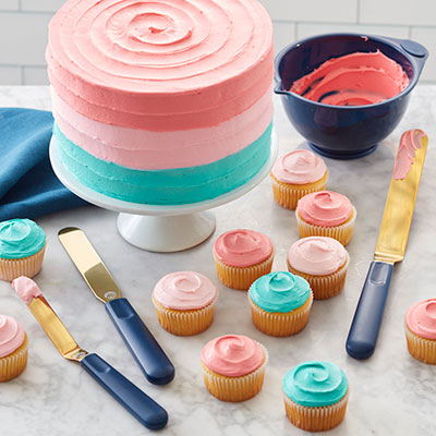 Cake with cupcakes and icing tools